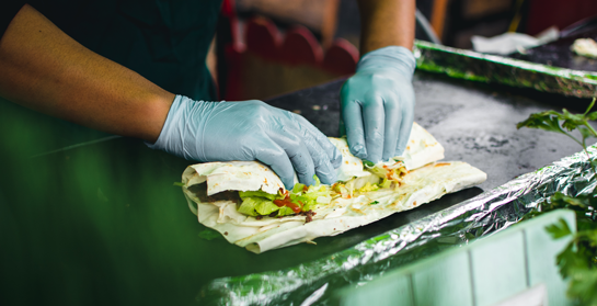 Worker making sandwich with gloves on | Farrow